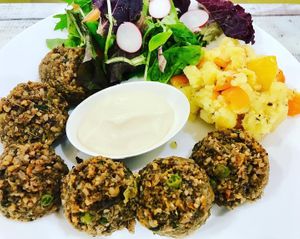 Meatballs with sides an vegan mayonnaise at Raparossa Bistrot in Bologna