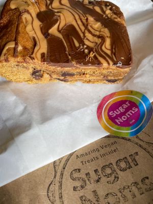 Peanut butter and chocolate chip cookie bar was incredible.  Had half cold and half warm. Both perfect with a coffee    at Sugar Noms in Redcar