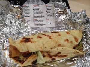 Chickpea and potato curry naan wrap with chilli sauce and salad at Curry Rolls in Gateshead