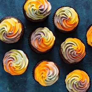 Custom Cupcakes Available!  These are Black Velvet cake with rainbow vanilla buttercream. at The Devil Wears Parsley Bakery in Columbia