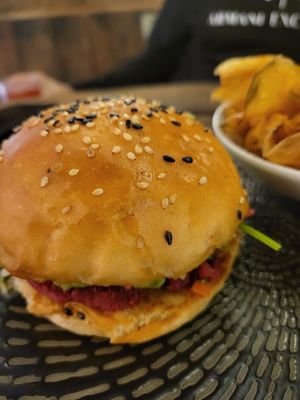 Lentil patty burger with home-made salsa and guacomole in a soft burger bun - amazing indeed at People of Tomorrow in New Delhi