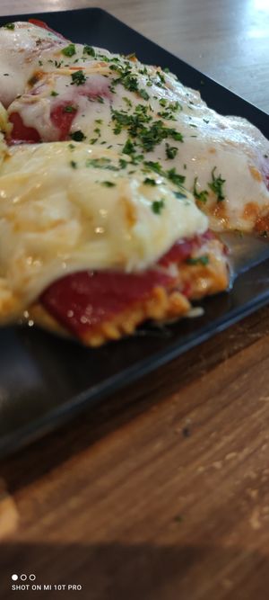 Del menú: Pimientos del piquillo rellenos con boloñesa de soja texturizada, gratinados con queso mozarella. at La Regina Restaurante in Madrid