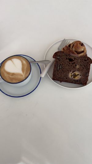 Café au lait avec banana bread et cinnamon roll  at All Things Dough in Lagos