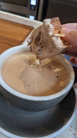 Double hot choco with a pain au chocolat at WAY Plant Based Bake House in Ghent