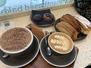 Double chocolate milk, coffee, mellow cake, snickers tart, croissants with cinnamon, chocolate and cream    at WAY Plant Based Bake House in Ghent