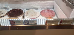 Flavor cards for 4 Non-dairy options. Sorbet at the back right, Butter Pecan to the left of it. at South Pier Creamery and Market in South Haven