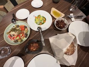 Vegan appetizer spread. Lahanodolamas, marinated olives, fresh baked sourdough with 5 year starter, house made olive oil and a greek salad!  at Flya Restaurant in Corfu
