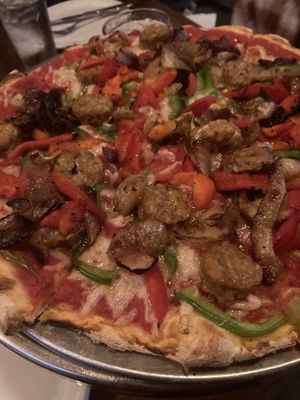 Vegan pizza with Smart Sausage, green peppers, roasted red peppers, caramelized  onions, vegan cheese!  at Pizzetta in Mystic