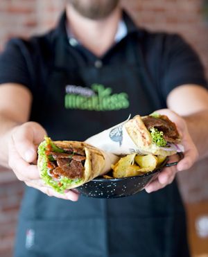 Wrapped pita with vegan yeeros, vegetables and humus at Kokos Pitta in Patras