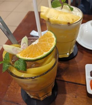 Orange lemongrass peach tea and pineapple juice at Nhà Hàng Chay NẤM in Phu Quoc