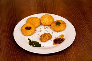 Moongdal Kachori — Deep-fried puffed pastry filled with yellow gram, served with green and tamarind chutney. (4 Pcs.) at Tatta Chulha in Vancouver