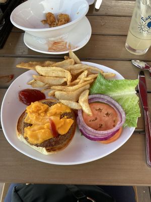 Impossible burger with vegan cheeze and a few tots behind    at Bay Cafe in Provincetown