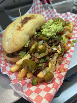 Torta de bistec with a side of asada fries   at La Buena Vida Restaurante Vegano in Laredo