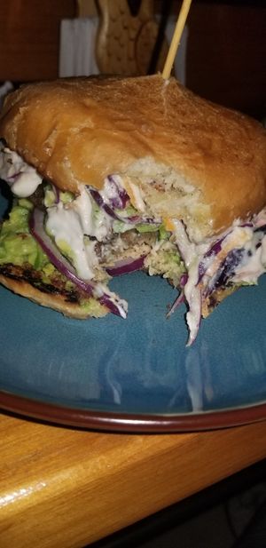 Spicy burger with coleslaw at Zen Eats in San Marcos La Laguna