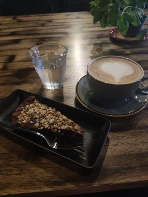 Chocolate hazelnut cake and latte at Ortica Italian Plant Based in Urmston