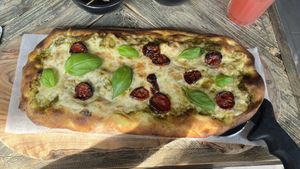 Beautiful pizza with pesto and sundried tomato   at Ortica Italian Plant Based in Urmston