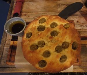 Focaccia Pugliese: Focaccia with olives served with olive oil and balsamic vinegar at Ortica Italian Plant Based in Urmston