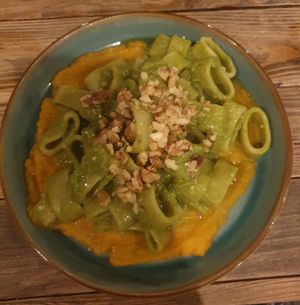 Calamarata Piselli e Zucca: Fresh calamarata pasta with peas and butternut squash cream, walnuts on top, evoo at Ortica Italian Plant Based in Urmston