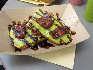 Avocado sourdough toast with sun-dried tomatoes and balsamic glaze at Squeezee in Barmouth