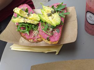 Beetroot hummus on sourdough toast with avocado, rocket and seeds at Squeezee in Barmouth