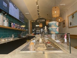 Narrow interior - all about ordering counter, some high stools and 2 small tables for eating in  at Pokéria by NIMA - Pisa in Pisa