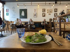 Vegan bagel and backdrop of the cafe   at Kalipso Artisan Coffee in Torquay