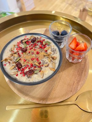 Salted Caramel and Almond Butter porridge with mixed berries and mixed seeds. Vegan - Gluten Free - Refined Sugar Free  at Love Live Light Healing Hub in Cardiff