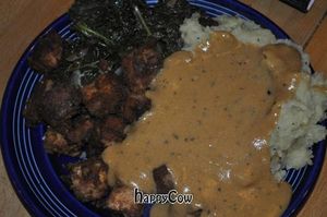 Peanut butter tofu, mashed potatoes with nutritional yeast gravy and greens at Rosetta's Kitchen in Asheville