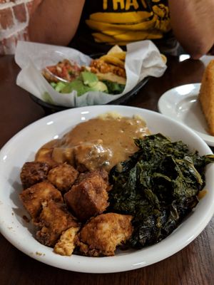 Family plate with peanut butter tofu, smashed potatoes and gravy, kale at Rosetta's Kitchen in Asheville