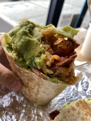 Al Pastor, Guac Sour, Creme, Lettuce, Tomato, Rice, Beans inside.  at Rojos Mexican Food in Seattle