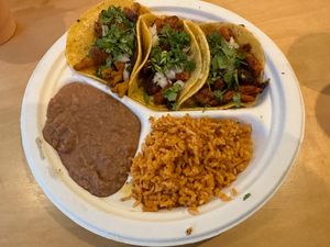 Three tacos platter with rice and beans  at Rojos Mexican Food in Seattle