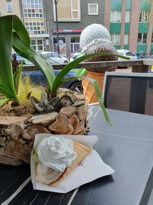 3 scoops (coconut, tiramisu and pistache) in a big cone with vegan whipped cream at CaffèNino IJs & Koffie - Nijmegen in Nijmegen