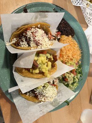 3 taco plate.  Chorizo (top), pastor (middle), asade (bottom).  Black beans, rice, salad with guacamole ranch drizzle .  at Tacotarian in San Diego