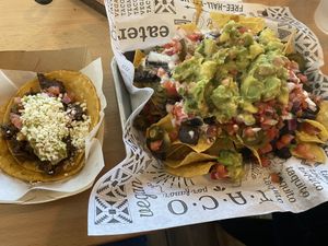 Nachos and carne asada taco  at Tacotarian in San Diego