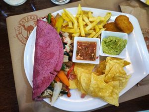 Quesadillas with vegan cheese, vegan bacon, vegan chicken, French fries, guacamole etc etc!  at Caravanserai in San Sebastian