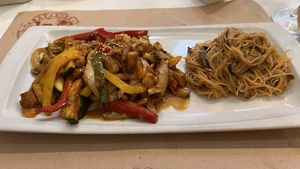 Vegan chicken with teriyaki sauce, wok-fried vegatables with sesame and soy sauce and sauteed Chinees noodles with mushrooms  at Caravanserai in San Sebastian