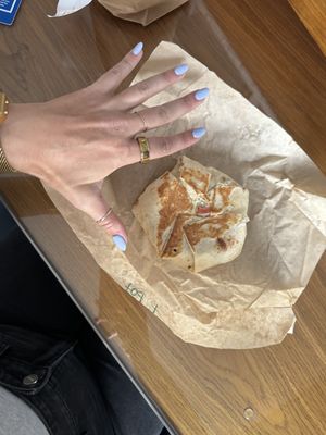 Vegan Crunchwrap with hand for scale of size  at Vegan Van @ Park Hill Kitchens in Denver