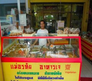 Owner behind the counter at entrance. at Mae Orathai Vegetarian in Phuket