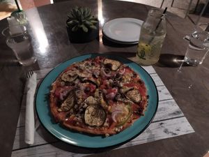 Homemade vegan pizza with grated tofu at Enasma Cafe in Crete