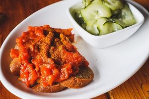 Vegan Currywurst - vegan brat topped with curry sauce; pictured with Cucumber Salad (vegan) at Kansas City Bier Company in Kansas City
