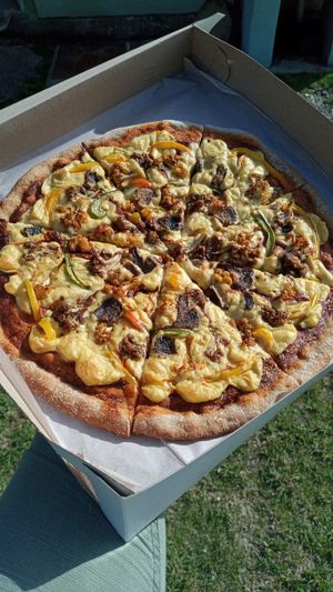 Plantbased pizza with cashew cheez, housemade marinara & optional toppings on a wholewheat crust. at A Vegan's Utopia in Montego Bay