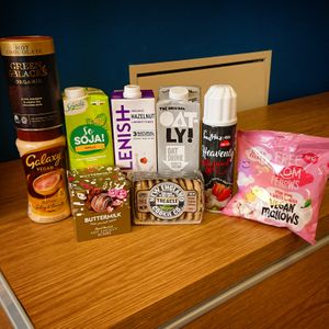 Plant based milks, hot choc powder, vegan marshmallows, dairy free squirty cream, and cookies at Planetamica in Narberth