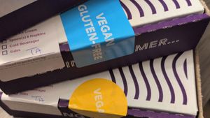 Box labels of vegan and vegan/gluten-free at Insomnia Cookies in Tallahassee