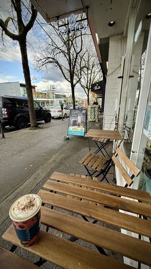 Three low ice cream tables indoors and two sidewalk tables outside    at Nuttea in Vancouver