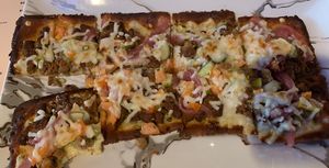 Very Vegan Flatbread (vegan motz, impossible sausage, vegan herb aioli, picked red onions, tomatoes, pickles, vegan flatbread dough)  at Derailed Taphouse in East Stroudsburg