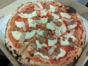 Vegan tuna, onion, and capers pizza at Vegano in Bangkok