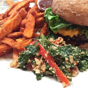 charred tempeh burger with yam fries! at Seva in Detroit