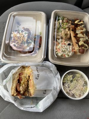 Tuna sandwich, pesto pasta salad, chili dog plate, and loaded red yams. at Veggie Grill by Next Level in Beaverton