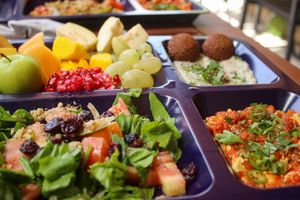 breakfast - fruit salad, moutabbal with falafel, shakshuka with tofu and salad at Carob Restaurant in Amman