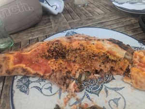 Half eaten ripieno ripieno pizza at Uga - Uga in Fuerteventura